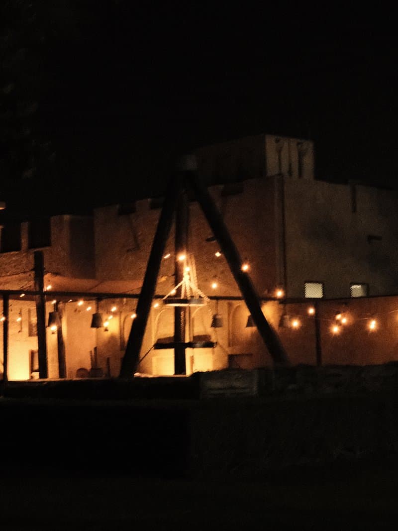 A dimly lit traditional building with decorative lights at night, creating a warm atmosphere.
