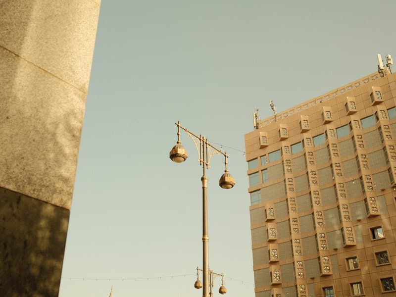 Urban scene featuring a street lamp and a modern building under a clear sky.