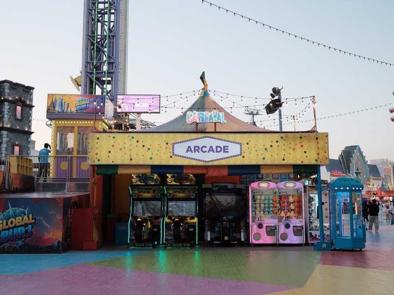 Colorful arcade building with games and a carnival atmosphere under a clear sky.