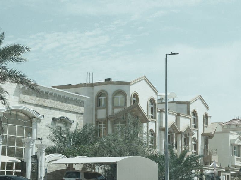 A row of modern buildings with unique architectural designs under a cloudy sky.