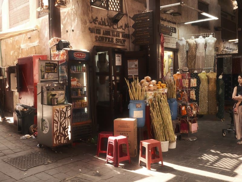 A vibrant street scene with colorful stalls and flowers in a bustling market.