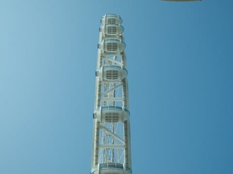 A tall observation tower against a clear blue sky.