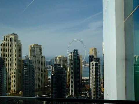 View of a city skyline with tall buildings and a clear blue sky in the background.