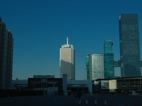 City skyline featuring modern skyscrapers against a clear blue sky.