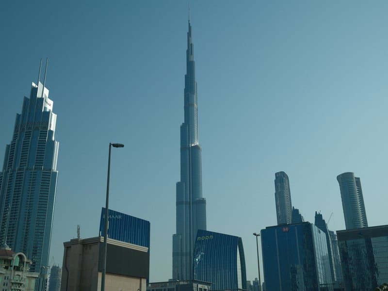 Skyline featuring the Burj Khalifa and surrounding skyscrapers under a clear blue sky.
