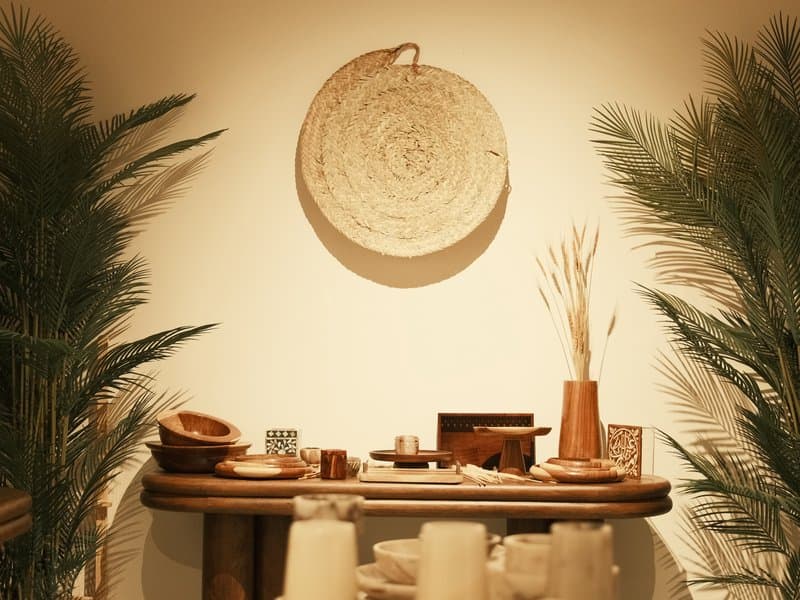 A cozy interior scene featuring a wooden table adorned with decorative items and plants.